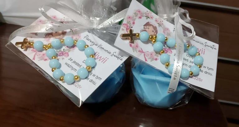 Handmade beaded bracelets with turquoise and gold beads packaged in cellophane with decorative labels and white ribbons